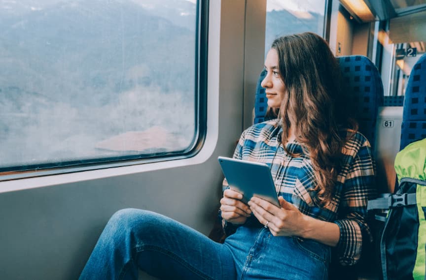 Women working with tablet on train